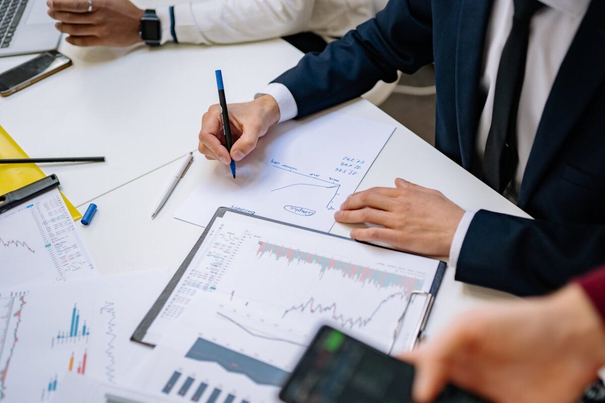 Professionals analyzing financial charts in a corporate setting.